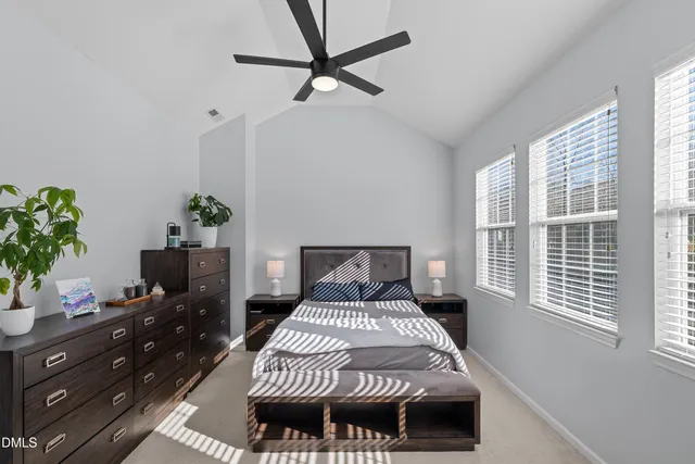 a dining room with wooden floor a chandelier a wooden table and chairs