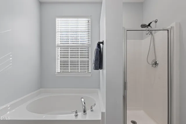 a bed room with a bed window and a potted plant
