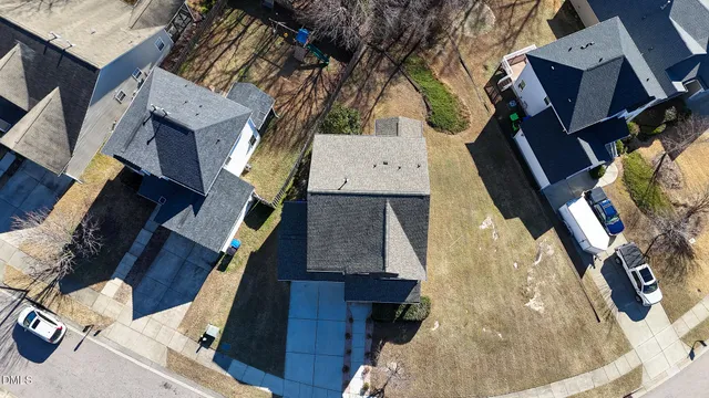 a bathroom with a sink a toilet a mirror and shower curtain