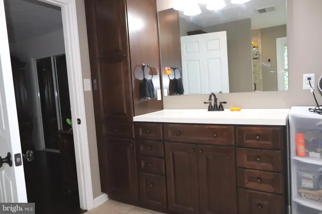 a view of a small space with wooden floor and a window