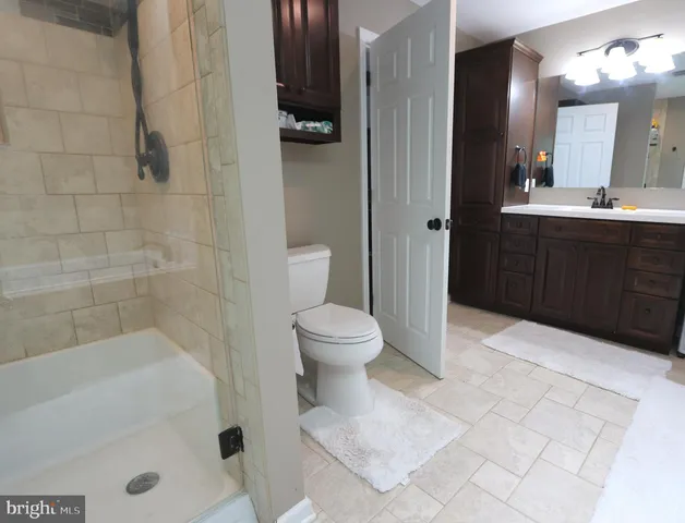 a living room with furniture a flat screen tv and a window