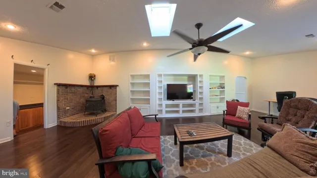 a view of a chair and tables in the back yard of the house