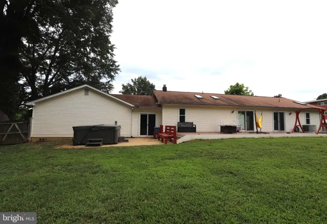 a view of a white house with a tree and plants