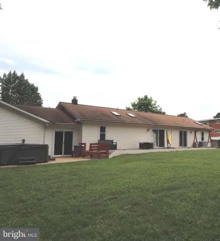 a bathroom with a granite countertop toilet and a sink