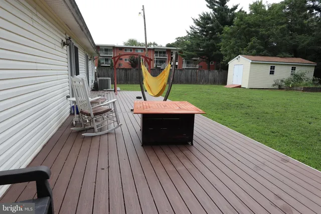 a view of a house with a yard porch and furniture