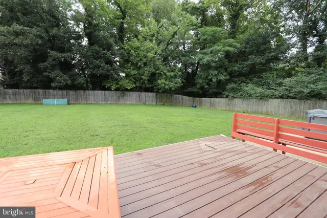 a view of yard with swimming pool and lawn chairs under an umbrella