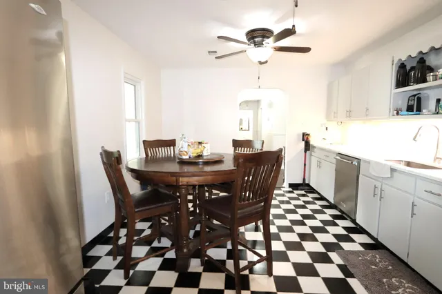 a bathroom with a tub shower sink and mirror