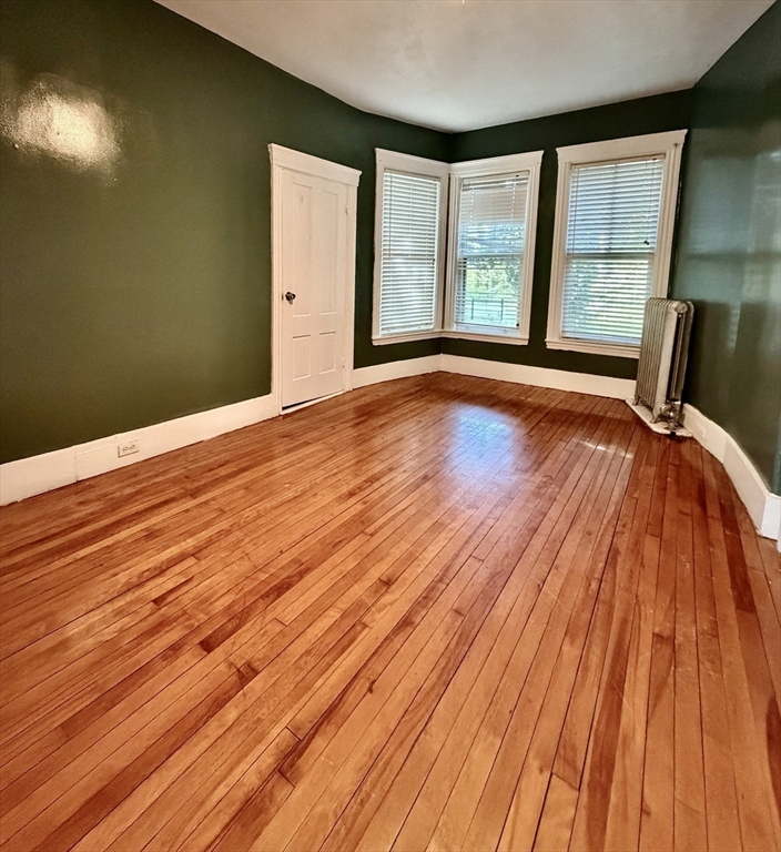 1 Congress Street, Unit 1 Worcester, MA 01609 - Photo 3 of 10 a view of an empty room with wooden floor and a window