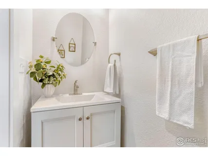 a bathroom with a sink vanity and a mirror