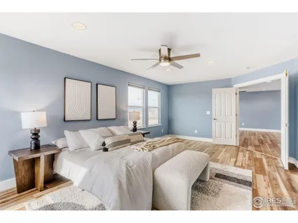 a bedroom with a large bed and a chandelier