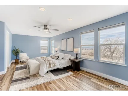 a bedroom with furniture and a large window