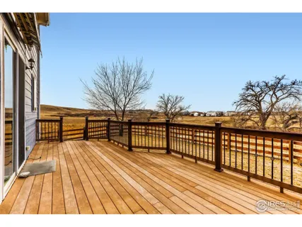 a view of balcony with wooden floor and fence