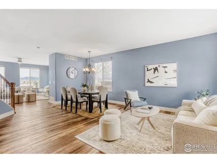 a living room with furniture and a dining table