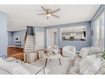 a living room with furniture and kitchen view