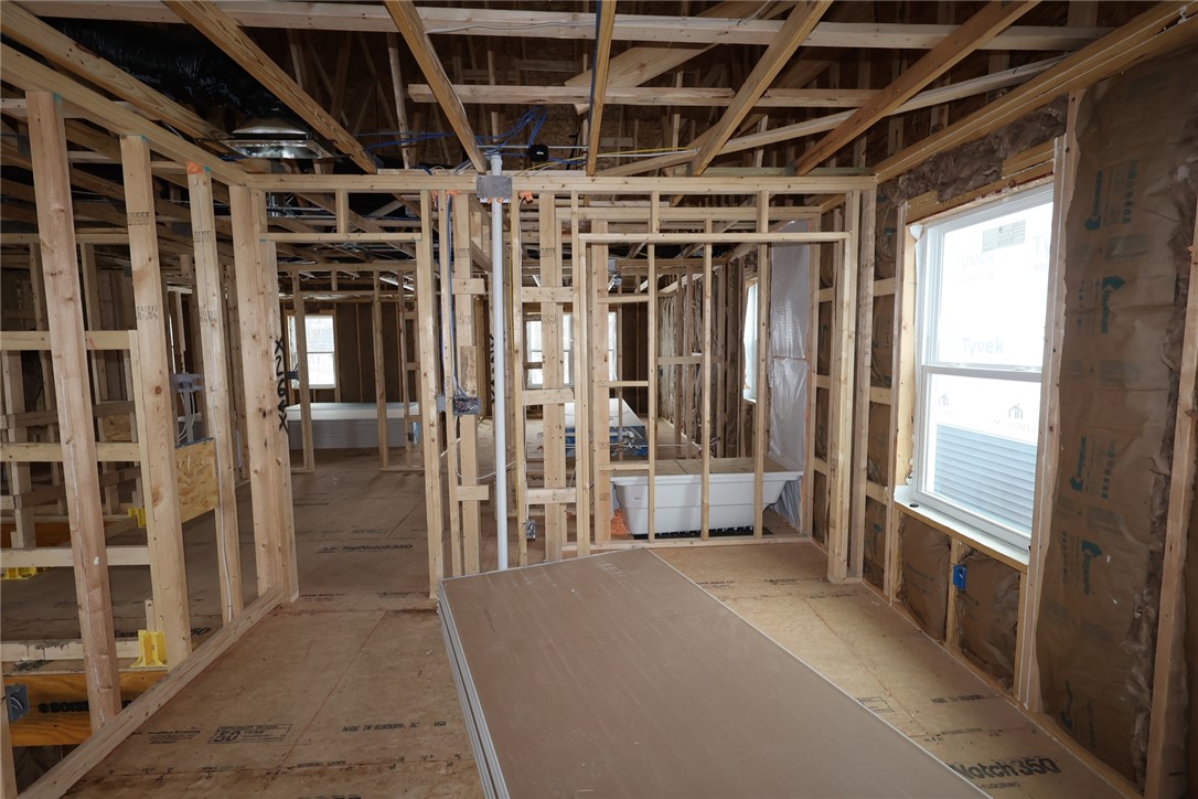 240 Tilly Court, Unit 5 Springboro, OH 45066 - Photo 7 of 26 This image captures the early stages of a home's construction, showcasing its structural framework and future potential.