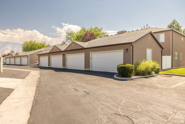 2 West 1780 North Logan, UT 84341 - Photo 17 of 24 View of front of property featuring community garages, stucco siding, and a shingled roof