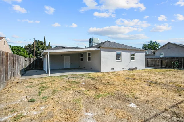 a view of a house with a backyard and a garden