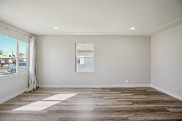 a view of a room with wooden floor and window