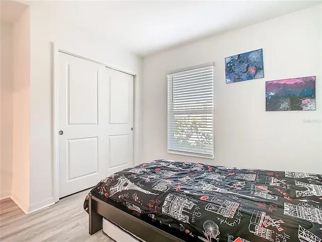 a bedroom with a bed and a window