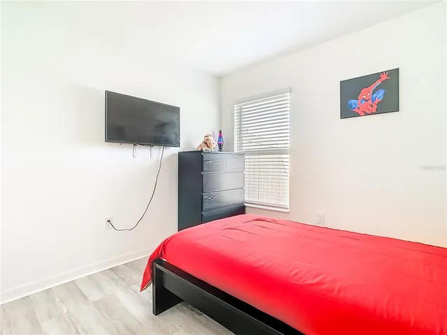 a bathroom with a granite countertop sink a toilet and a mirror