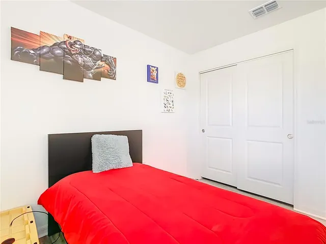 a bedroom with a bed and dresser