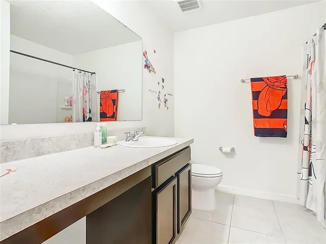 a bedroom with a bed and a night stand