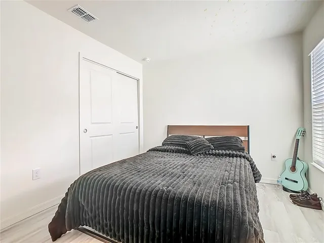 a bedroom with a bed and a night stand