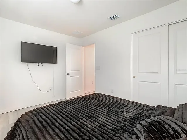 a bedroom with a bed and a night stand