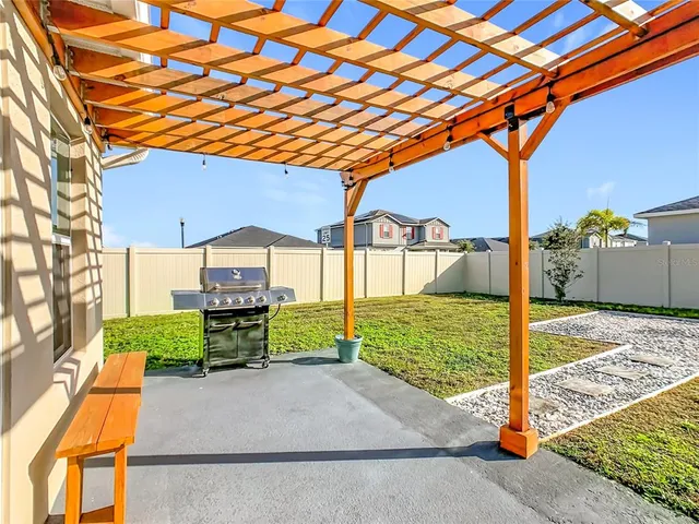 a view of a house with a yard and potted plants