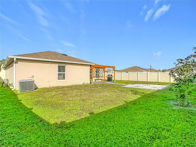 an aerial view of residential house with outdoor space and swimming pool