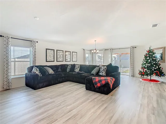 a living room with furniture and kitchen view