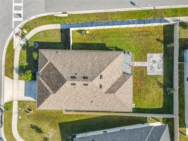 an aerial view of residential houses with outdoor space