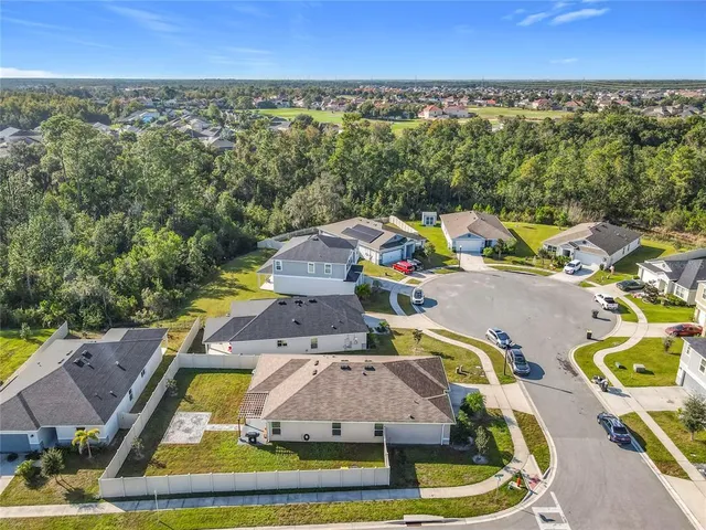 an aerial view of a house with a yard and lake view