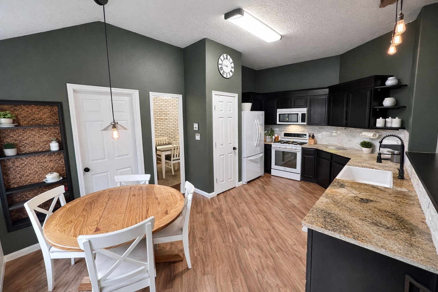21510 Forest Colony Drive Porter, TX 77365 - Photo 6 of 19 a kitchen with stainless steel appliances kitchen island granite countertop a sink refrigerator and cabinets