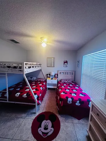 a bathroom with a granite countertop sink a toilet and a shower