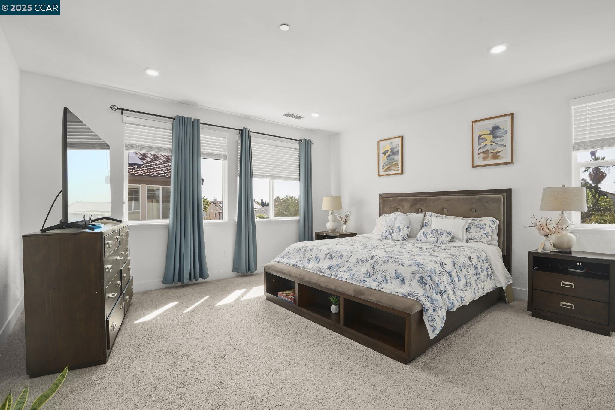 433 Ramos Ranch Road Oakley, CA 94561 - Photo 16 of 25 a spacious bedroom with a bed and wooden floor