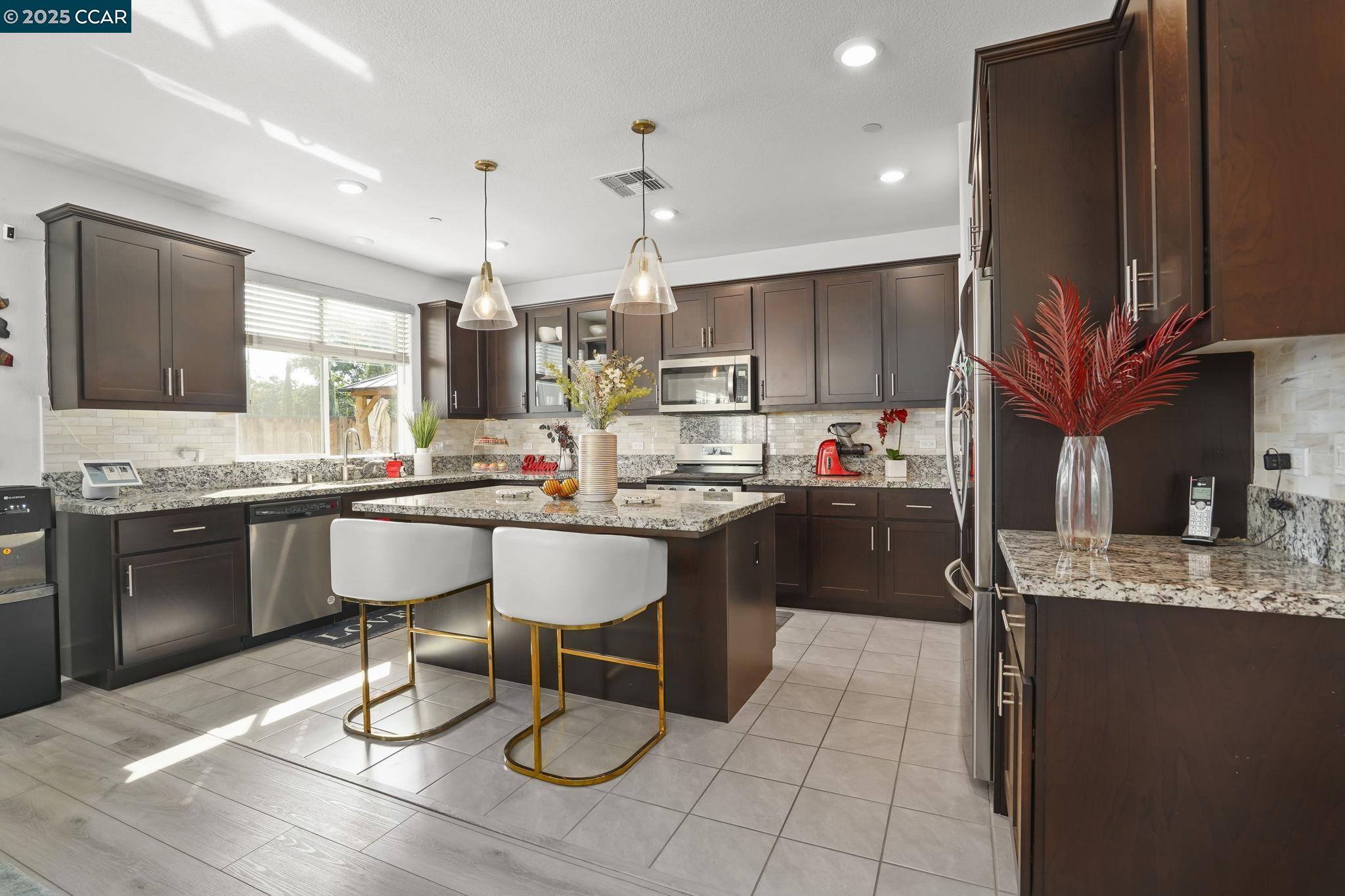 433 Ramos Ranch Road Oakley, CA 94561 - Photo 9 of 25 a kitchen with a sink cabinets and counter space