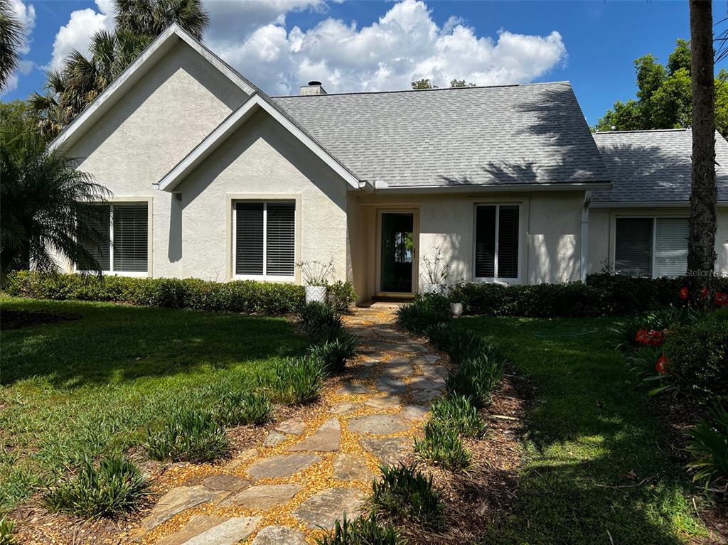 12595 Southeast Sunset Harbor Road Weirsdale, FL 32195 - Photo 1 of 25 a view of a house with garden and a sitting area