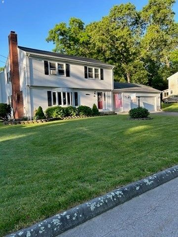 a front view of a house with a garden