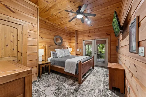 a bed room with a bed and a large window