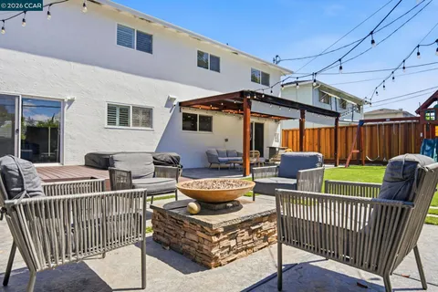 a view of backyard with a patio and outdoor seating
