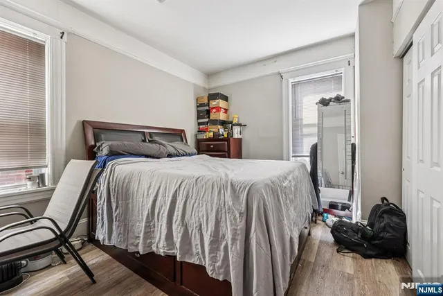 a bedroom with a bed and a book shelf