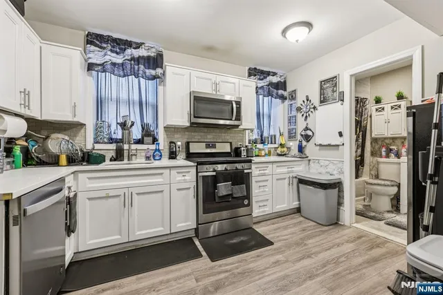 a kitchen with a refrigerator stove and sink