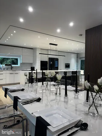 a view of kitchen with stainless steel appliances dining table and chair