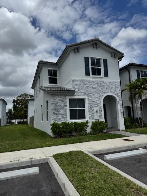 16283 Southwest 292nd Street Homestead, FL 33033 - Photo 2 of 29 a front view of a house with a garden