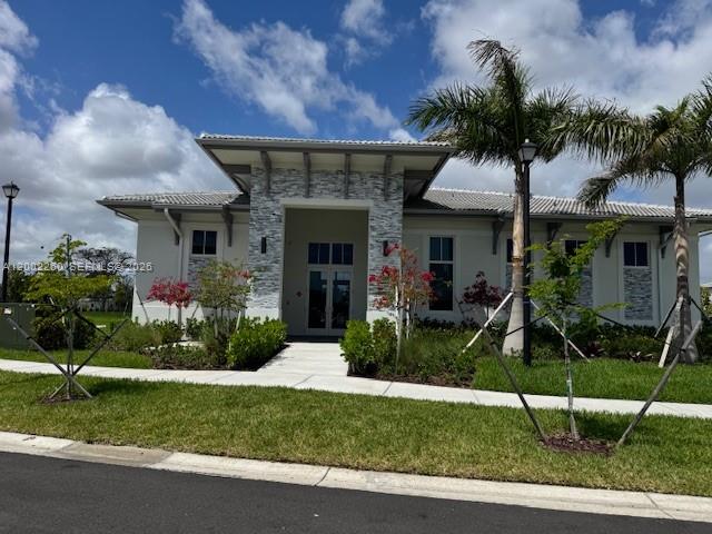 16283 Southwest 292nd Street Homestead, FL 33033 - Photo 27 of 29 a view of a house with a yard and potted plants
