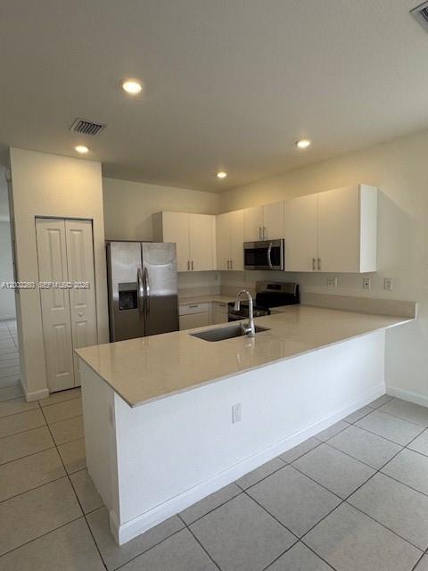16283 Southwest 292nd Street Homestead, FL 33033 - Photo 3 of 29 a large kitchen with kitchen island a sink a counter and stainless steel appliances