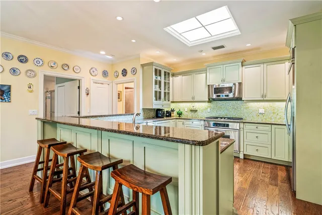 a kitchen with stainless steel appliances granite countertop a sink and cabinets