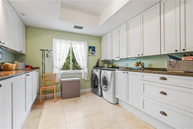 a kitchen with white cabinets and refrigerator