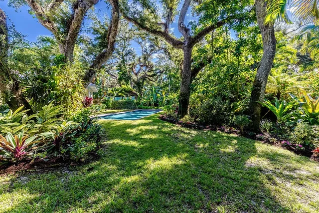 a view of a pathway of a house with a yard